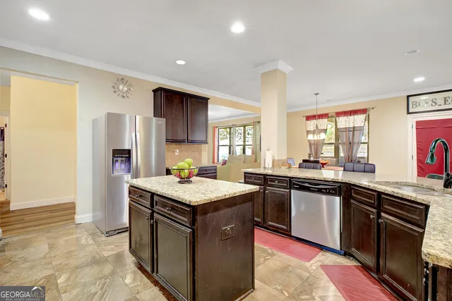 a kitchen with stainless steel appliances granite countertop a sink stove and refrigerator