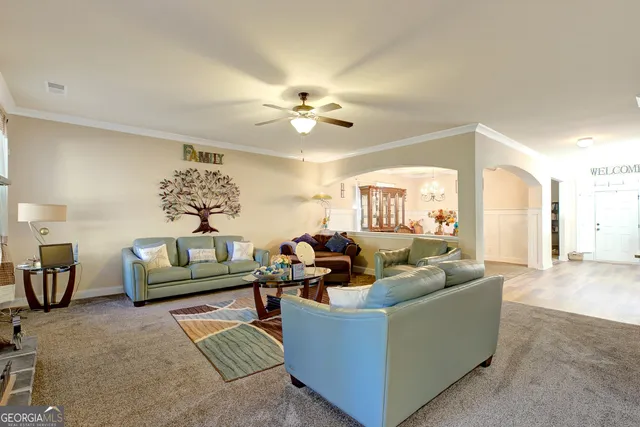 a living room with furniture and a chandelier