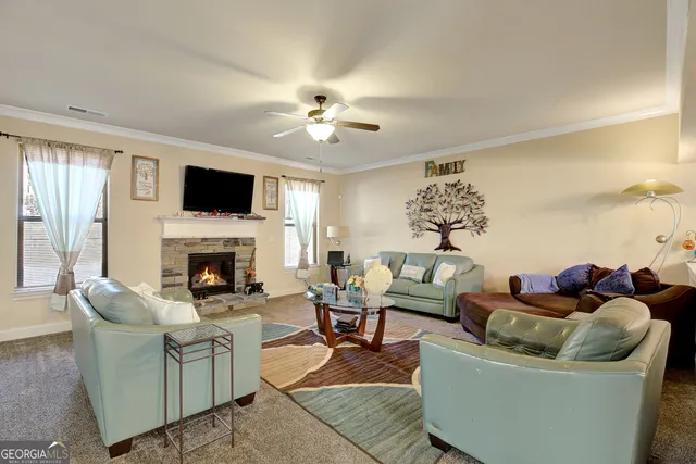 a living room with furniture a fireplace and a flat screen tv