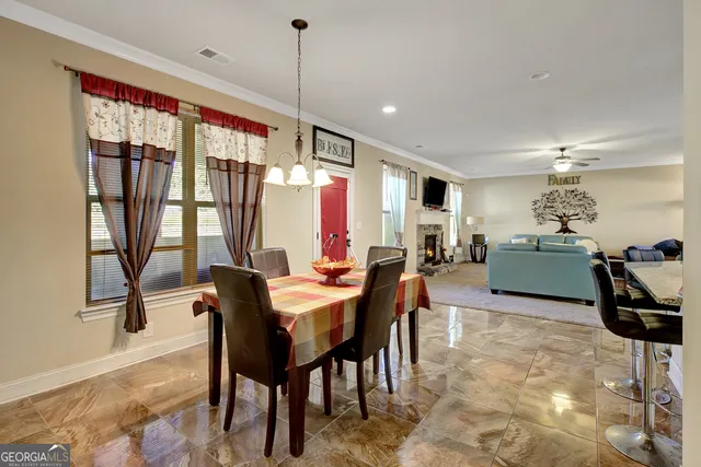 a living room with furniture kitchen view and a table