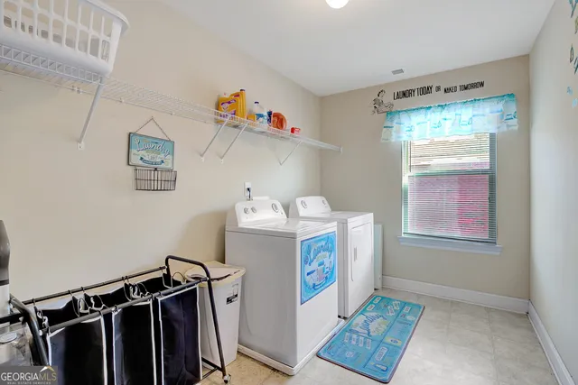 a bedroom with a bed and a flat screen tv with kitchen view