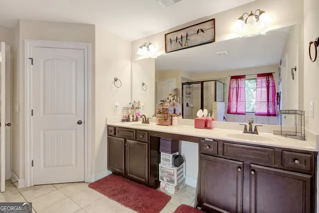 a bedroom with a bed lamp and a large window with the outer view