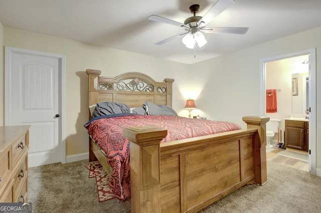 a bathroom with a granite countertop sink a toilet and shower