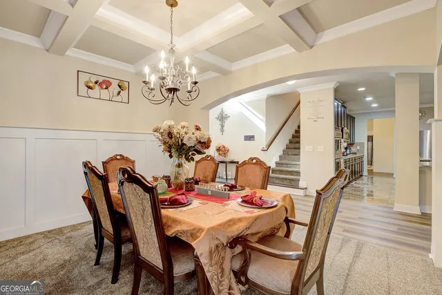 a view of a dining room with furniture and chandelier