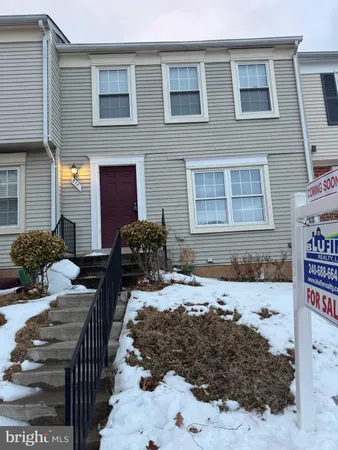 a view of a brick house with many windows