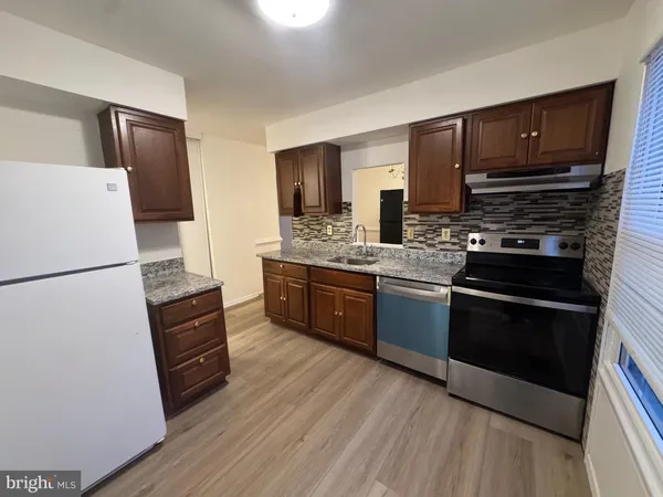 a kitchen with stainless steel appliances a refrigerator stove and sink