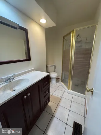 a bathroom with a sink a toilet and mirror