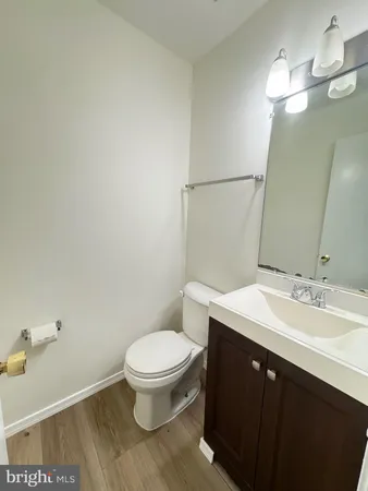 a bathroom with a sink a toilet a mirror and vanity