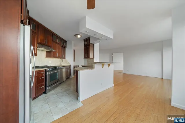 a kitchen with a sink cabinets and stainless steel appliances