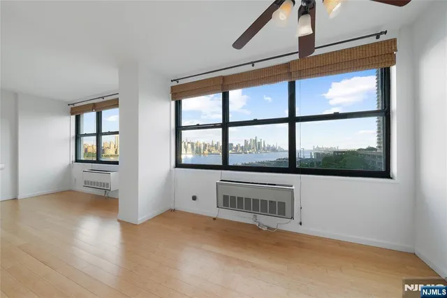 a view of a room with wooden floor