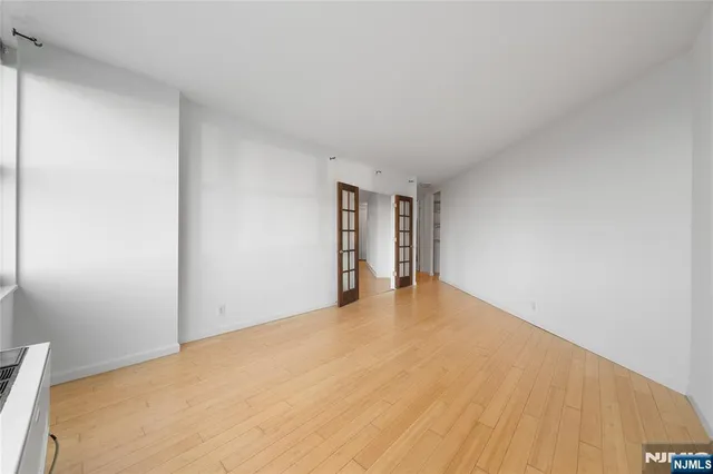 a view of an empty room and wooden floor