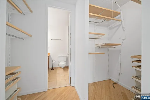 a bathroom with a granite countertop toilet sink and mirror