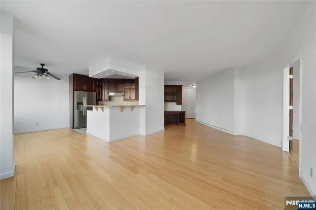 a view of a kitchen with a sink and a refrigerator