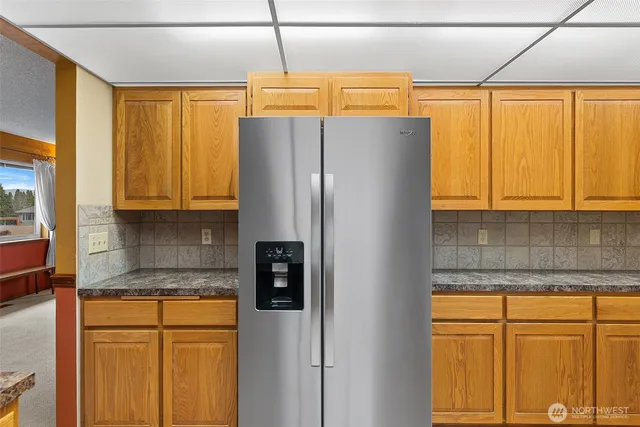a kitchen with stainless steel appliances granite countertop a refrigerator and a sink