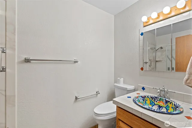 a bathroom with a sink toilet and shower