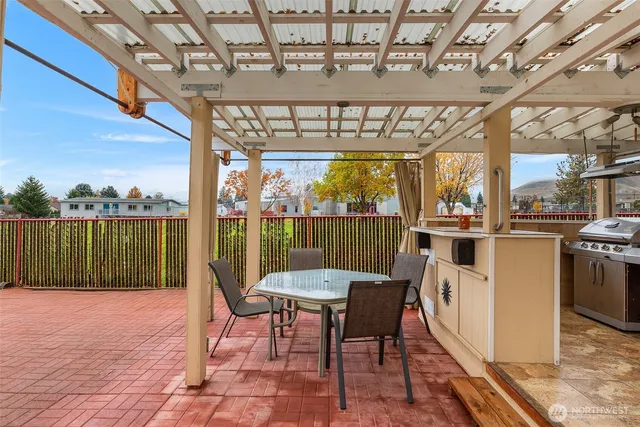a view of a dining room with furniture a chandelier and window