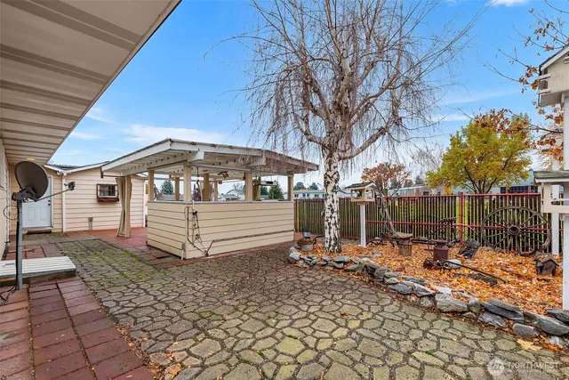 a backyard of a house with table and chairs