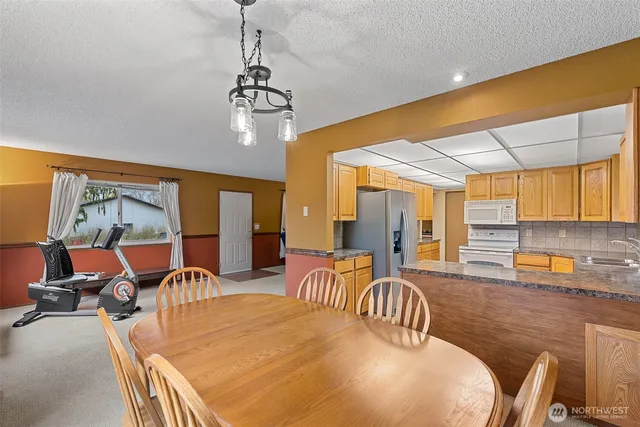 a kitchen with refrigerator and cabinets