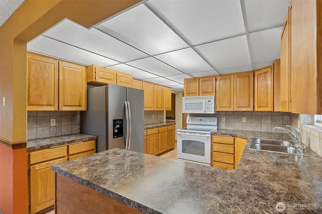 a kitchen with a sink a window and cabinets