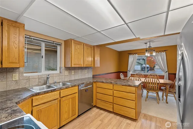 a kitchen with stainless steel appliances granite countertop a refrigerator and cabinets