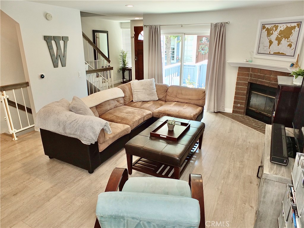 117 West Spring Street, Unit E Long Beach, CA 90806 - Photo 1 of 44 a living room with furniture and a fireplace