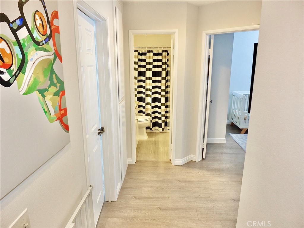 117 West Spring Street, Unit E Long Beach, CA 90806 - Photo 18 of 44 a view of hallway with wooden floor and window