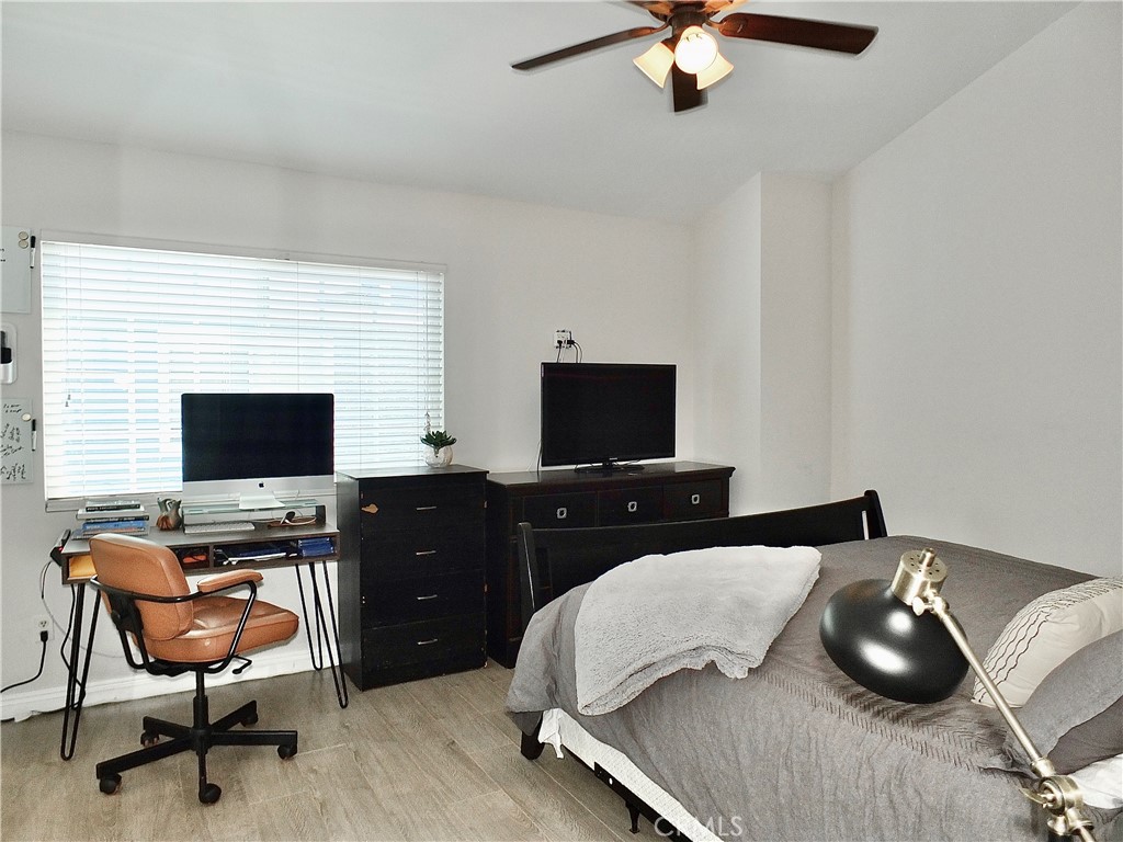 117 West Spring Street, Unit E Long Beach, CA 90806 - Photo 19 of 44 a bedroom with a bed and a flat screen tv
