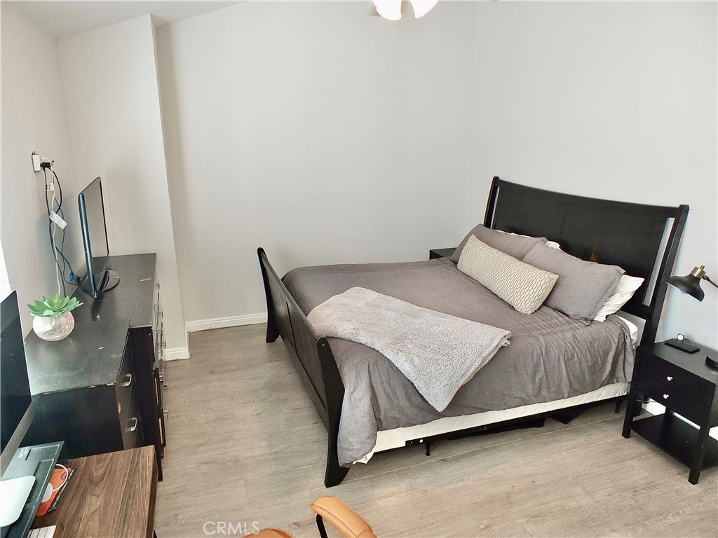 117 West Spring Street, Unit E Long Beach, CA 90806 - Photo 21 of 44 a bedroom with a bed and a chair