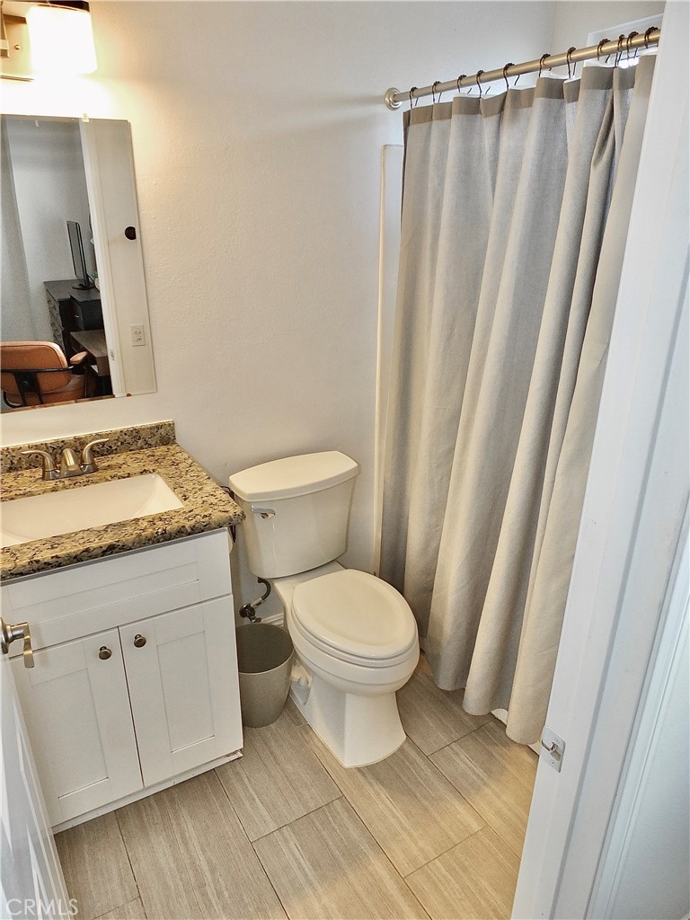 117 West Spring Street, Unit E Long Beach, CA 90806 - Photo 23 of 44 a bathroom with a sink and a mirror