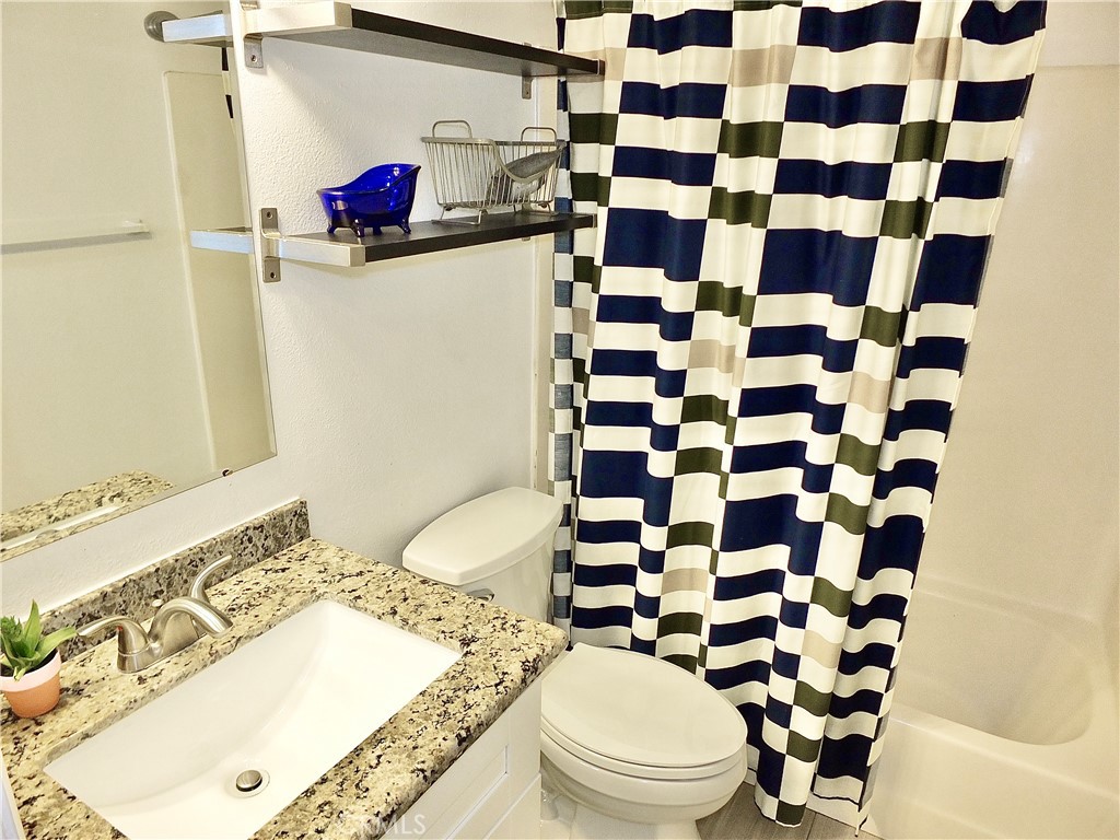 117 West Spring Street, Unit E Long Beach, CA 90806 - Photo 27 of 44 a bathroom with a sink toilet and shower