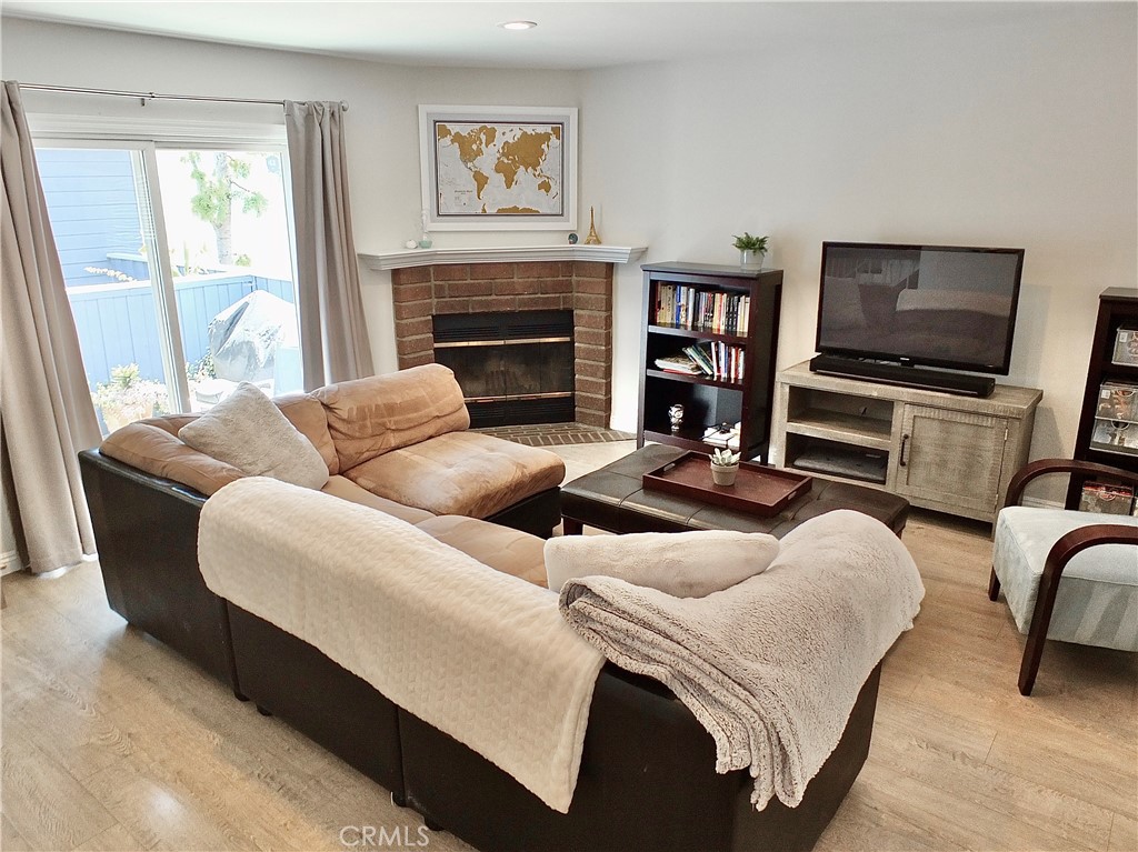 117 West Spring Street, Unit E Long Beach, CA 90806 - Photo 3 of 44 a living room with furniture and a flat screen tv