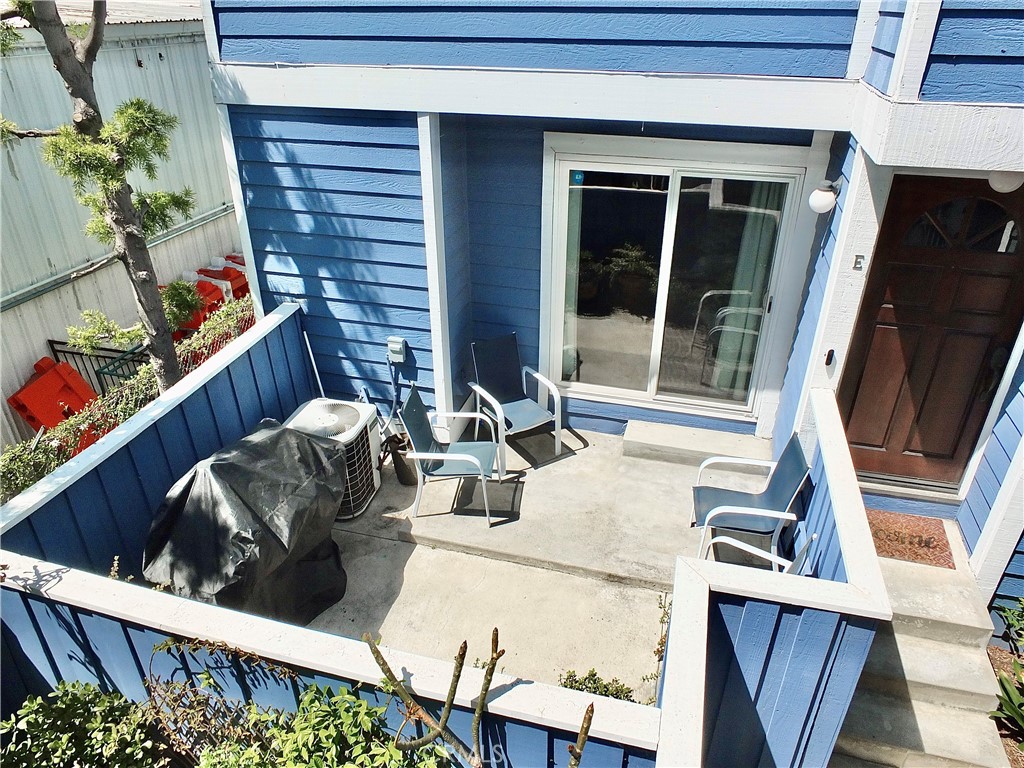 117 West Spring Street, Unit E Long Beach, CA 90806 - Photo 36 of 44 a living room with furniture and a floor to ceiling window