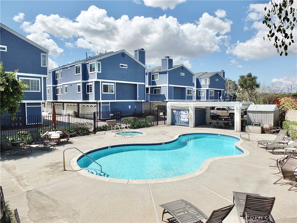 117 West Spring Street, Unit E Long Beach, CA 90806 - Photo 40 of 44 a view of a house with swimming pool and sitting area