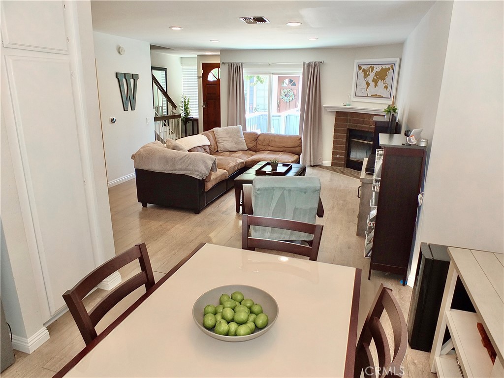 117 West Spring Street, Unit E Long Beach, CA 90806 - Photo 7 of 44 a living room with furniture and a fireplace
