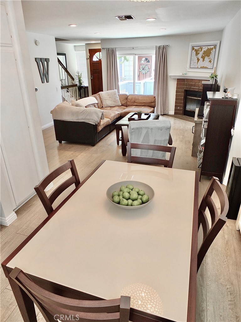 117 West Spring Street, Unit E Long Beach, CA 90806 - Photo 8 of 44 a living room with furniture and a fireplace