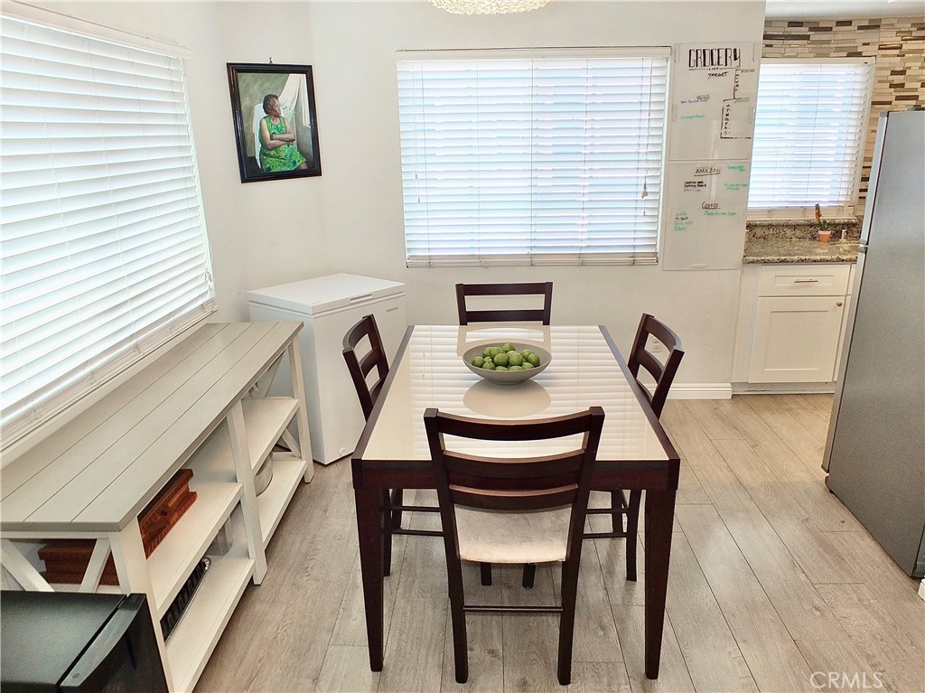 117 West Spring Street, Unit E Long Beach, CA 90806 - Photo 9 of 44 a view of a dining room with furniture and window