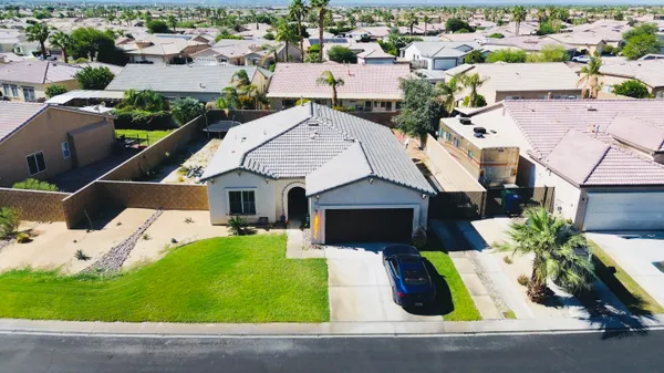 an aerial view of a house with garden space and street view