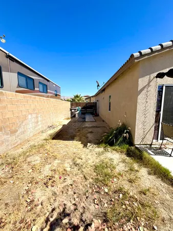 a view of a house with a yard and wooden fence