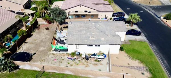 an aerial view of residential houses with outdoor space and parking