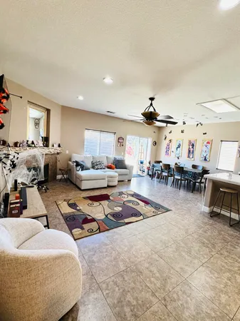 a living room with lots of furniture and view of kitchen