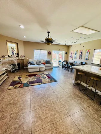 a living room with lots of furniture and a chandelier