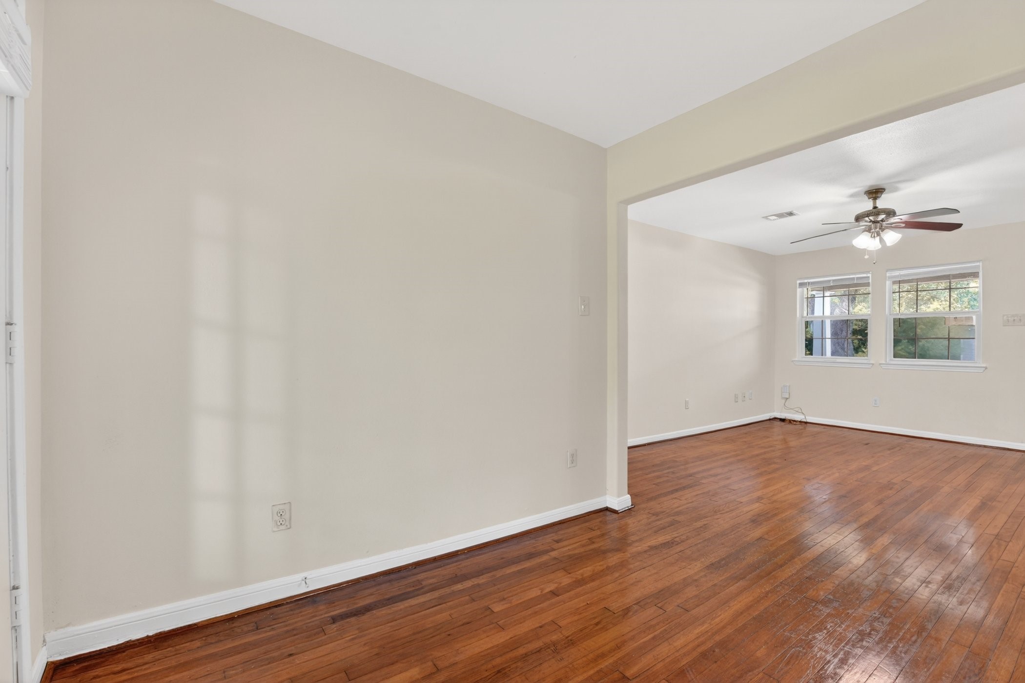 7013 St Augustine Street Houston, TX 77021 - Photo 13 of 35 an empty room with wooden floor and windows