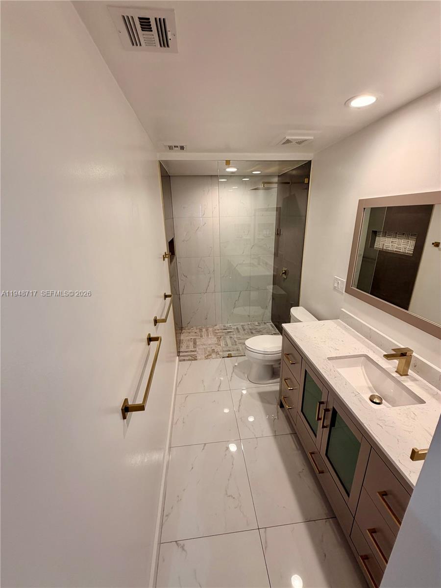 18709 Southwest 28th Street Miramar, FL 33029 - Photo 12 of 14 a bathroom with a sink a toilet and shower