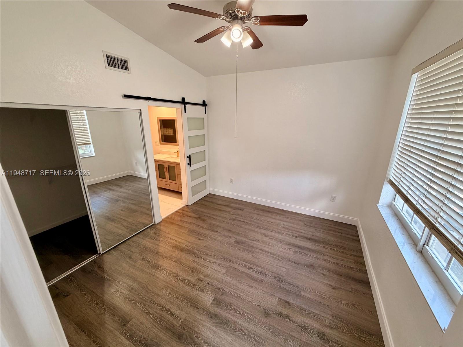 18709 Southwest 28th Street Miramar, FL 33029 - Photo 13 of 14 wooden floor in an empty room with a window