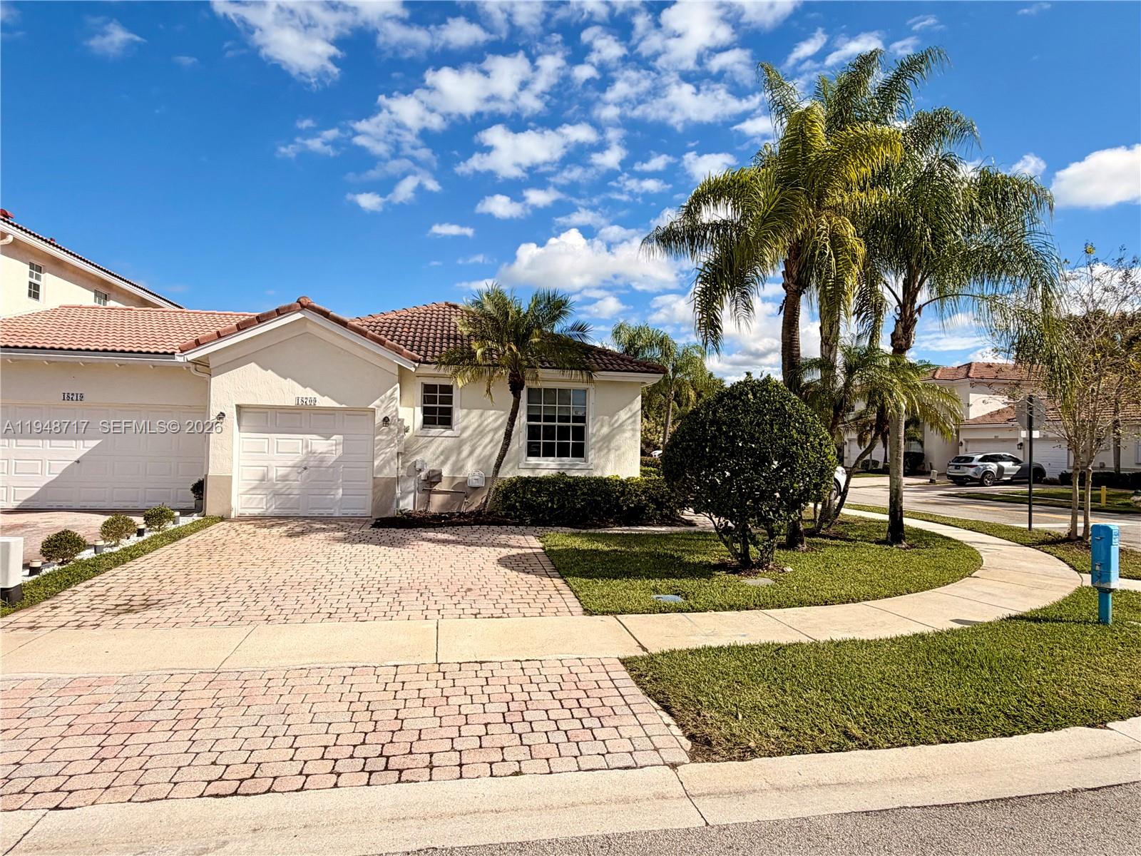 18709 Southwest 28th Street Miramar, FL 33029 - Photo 2 of 14 a front view of a house with a garden and yard