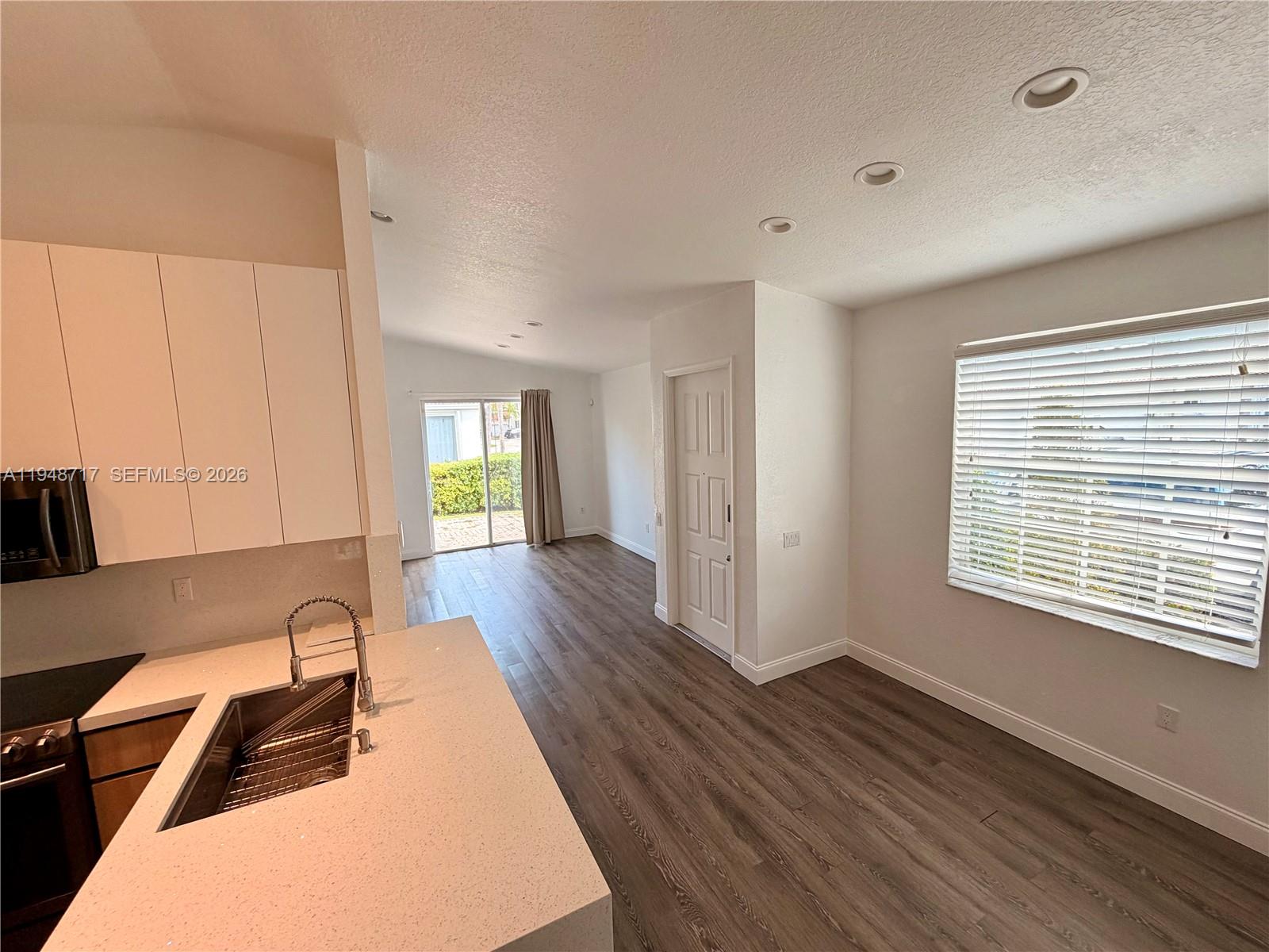 18709 Southwest 28th Street Miramar, FL 33029 - Photo 6 of 14 a view of an empty room with window and wooden floor