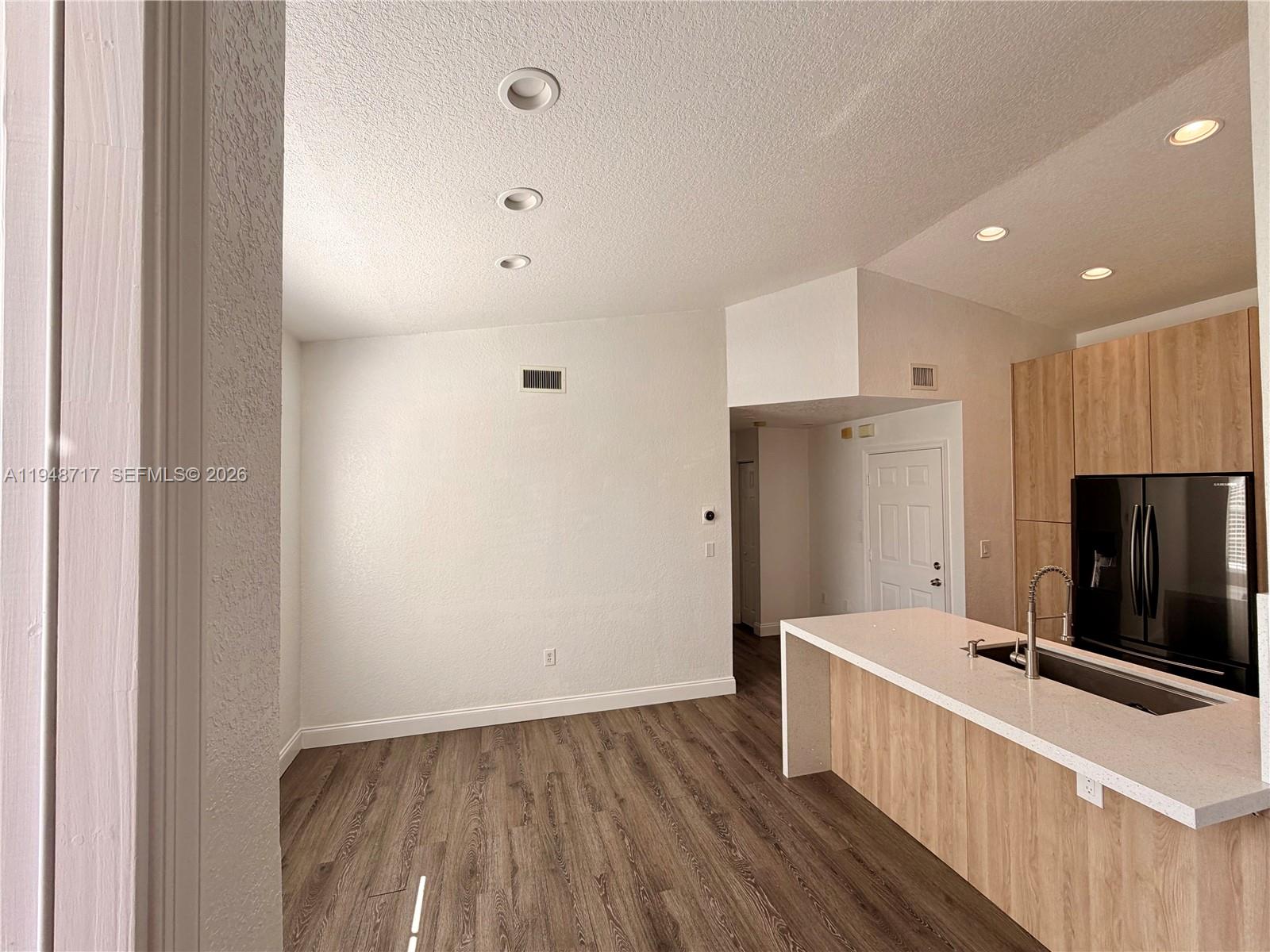 18709 Southwest 28th Street Miramar, FL 33029 - Photo 7 of 14 a view of kitchen with wooden floor