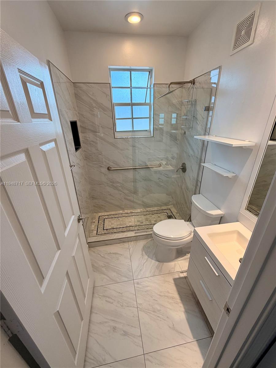 18709 Southwest 28th Street Miramar, FL 33029 - Photo 10 of 14 a bathroom with a granite countertop sink toilet and shower