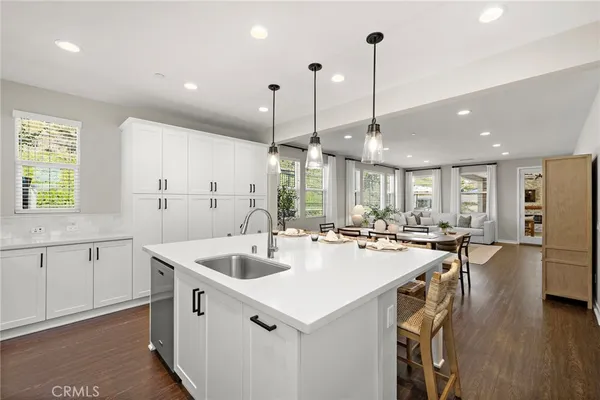 a kitchen with counter top space appliances and windows