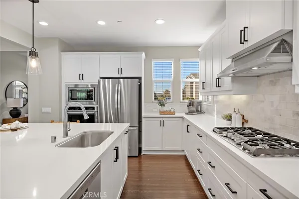 a kitchen with a stove sink and refrigerator